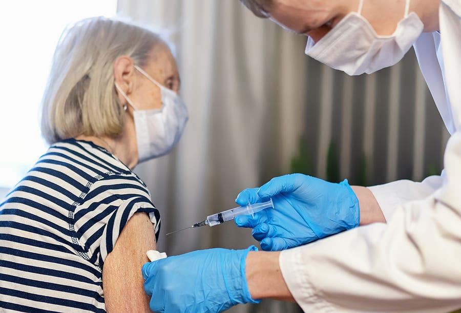elderly woman getting vaccinated for COVID-19