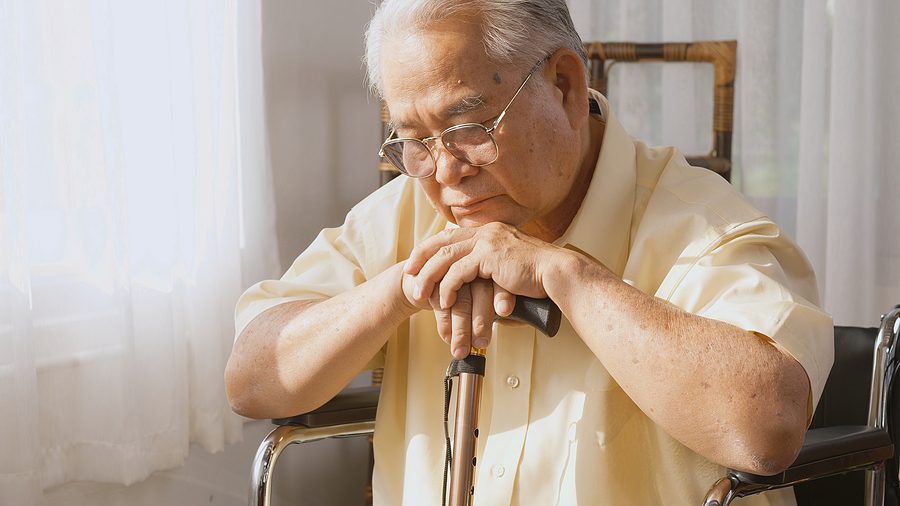 in-home care concept - sad elderly man in wheelchair