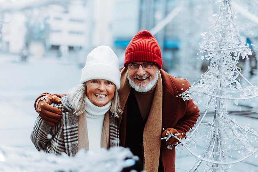happy seniors in the winter in a city - elder care concept