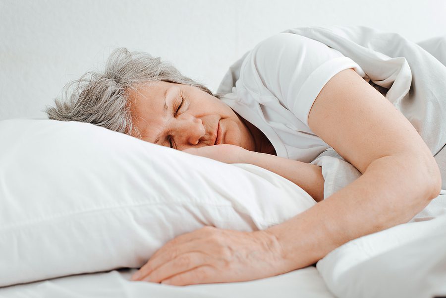 senior woman sleeping in bed - senior sleep schedules concept