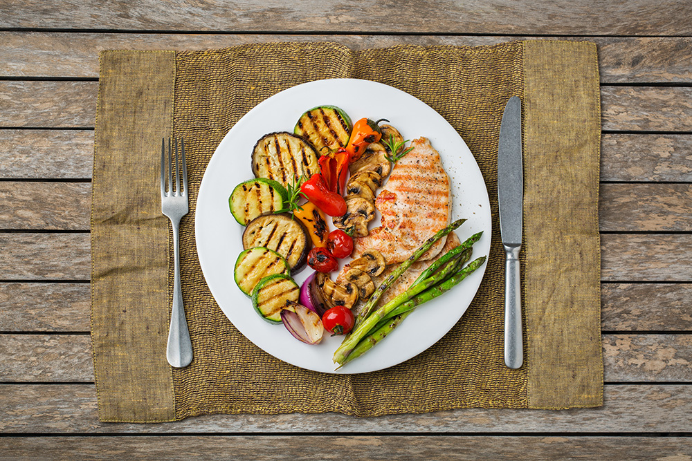 grilled chicken and colorful vegetables - appetite loss for older adults concept