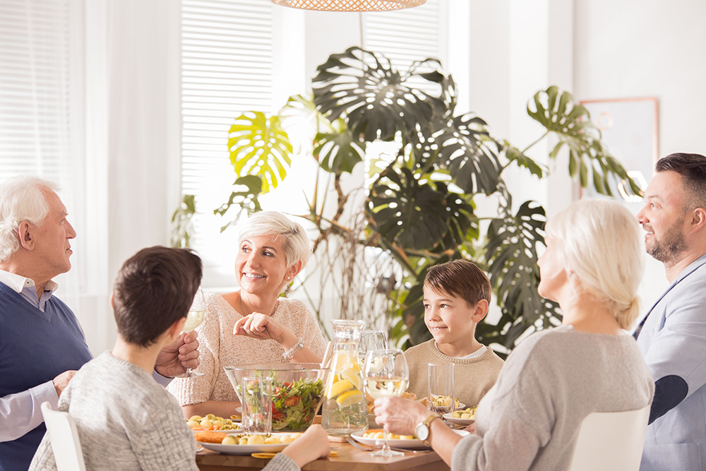 multi-generational family eating together - elder family living arrangements