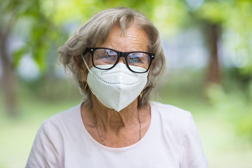 older woman wearing a mask to protect against cold, flu, or covid-19
