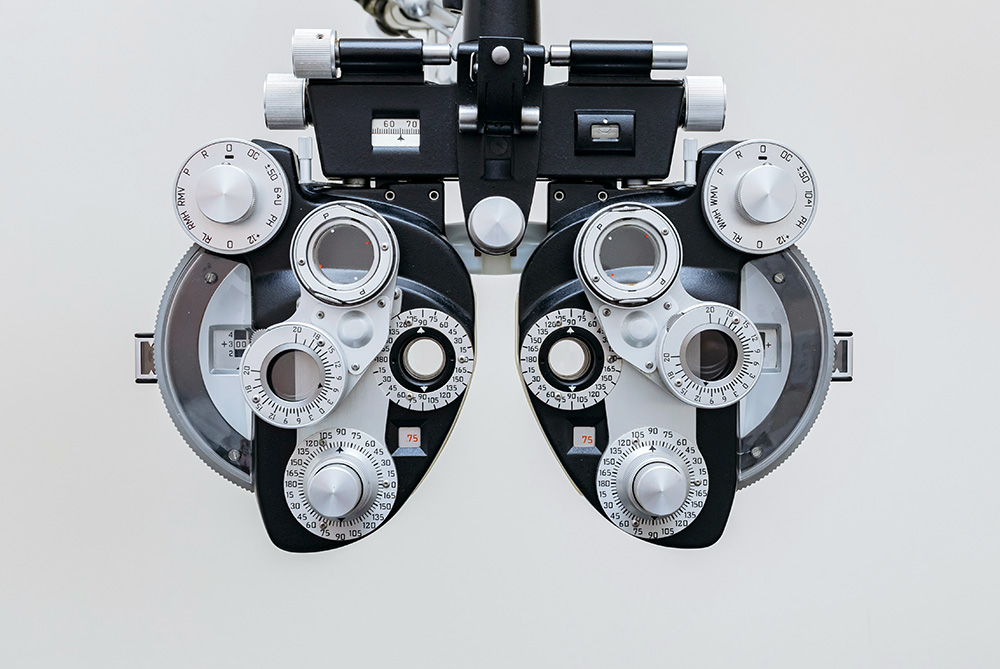 optometrist eye exam tool at eye doctor's office - eye screenings concept