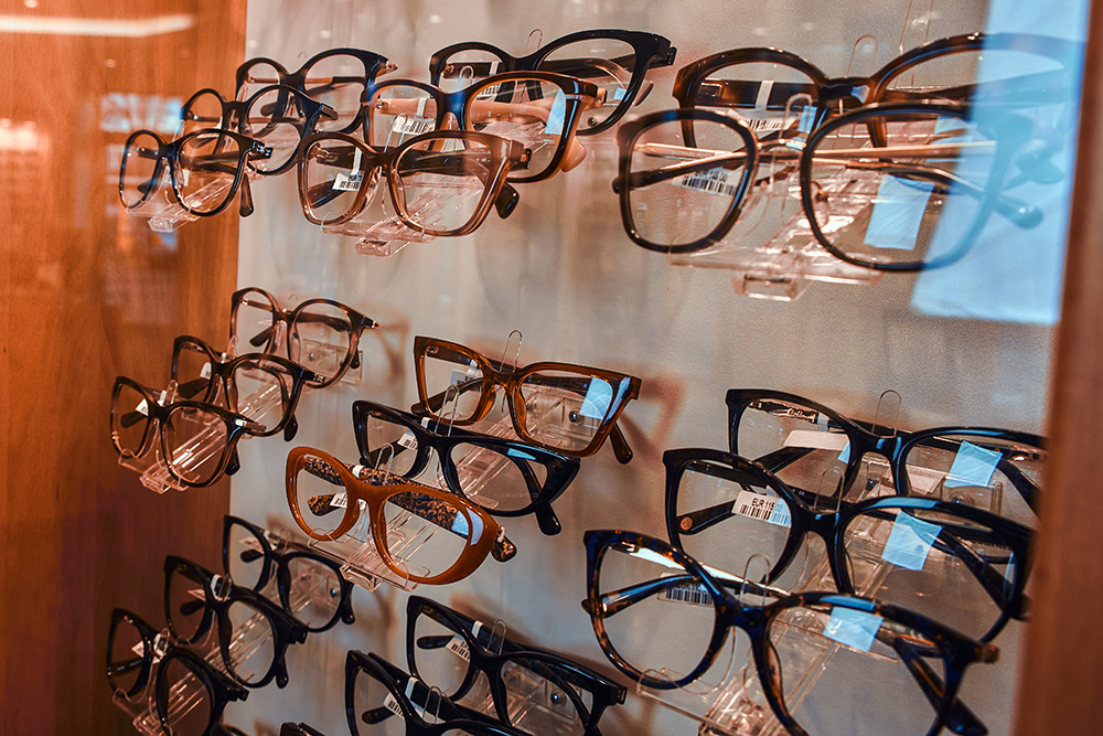 modern glasses frames at a eyeglass store - vision issues in older adults concept